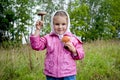 The girl holds mushrooms in hands