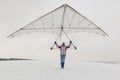 Girl holds an old hang glider wing
