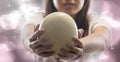 Girl holds ostrich egg straight toward the camera. Royalty Free Stock Photo