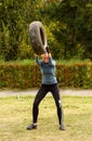 Girl holds over the head of tire.