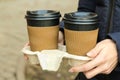 The girl holds paper cups for hot drinks in her hands. coffee to go.