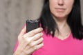 The girl holds a personal taser in her hands to protect against bandits. A woman will use a stun gun with a powerful electric