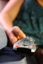 Girl holds remote control for TV