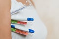 The girl holds several thermometers of different types at once, close up Royalty Free Stock Photo