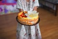 The girl holds a small, beautiful cake. House birthday Royalty Free Stock Photo