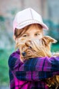 The girl holds a small dog breed Yorkshire Terrier on her hands_ Royalty Free Stock Photo
