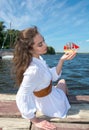 Girl holds a small ship with red sails. Modern Assol. Royalty Free Stock Photo