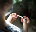 A girl holds thermometer. Close up view. Shallow depth of field.