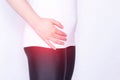 The girl holds on to the hip joint in which pain and inflammation, arthrosis and arthritis in the thigh, ankylosing spondylitis,