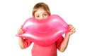 Girl holds toy, inflatable pink lips.