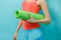 Girl holds twisted fitness mat