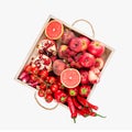 Girl holds wooden tray with fresh red vegetables and fruits on white background. Healthy eating vegetarian concept. Royalty Free Stock Photo