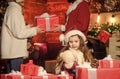 Girl at home on christmas eve. Adopting child. Kid celebrate new year with pile of gifts. Christmas traditions. Charity