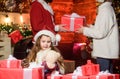 Girl at home on christmas eve. Adopting child. Kid celebrate new year with pile of gifts. Christmas traditions. Charity