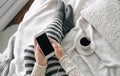 Girl home clothes smartphone cup coffee bed Royalty Free Stock Photo