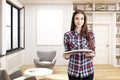 Girl in a home library with gray armchairs Royalty Free Stock Photo