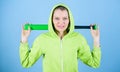 Girl hooded jacket hold baseball bat blue background. Baseball female player concept. She is dangerous. Sport game