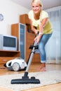 Girl hoovering in living room