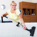 Girl hoovering in living room