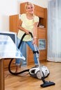 Girl hoovering in living room Royalty Free Stock Photo