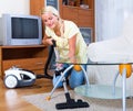 Girl hoovering in living room