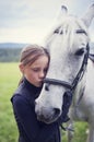 Girl with horse. Friendship between a girl and a horse. The girl is petting a horse Royalty Free Stock Photo