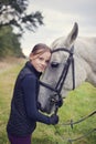 Bautiful lovely portrait girl with horse. Friendship between a girl and a horse. The girl is petting a horse Royalty Free Stock Photo