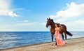 Girl with horse on seacoast Royalty Free Stock Photo