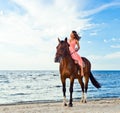 Girl with horse on seacoast Royalty Free Stock Photo