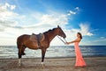 Girl with horse on seacoast Royalty Free Stock Photo