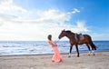 Girl with horse on seacoast Royalty Free Stock Photo