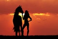 Girl and horse silhouette at sunset Royalty Free Stock Photo