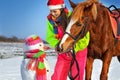 Girl, horse and snowman Royalty Free Stock Photo