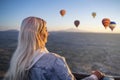 Girl in a hot air balloon watching the sunrise, hot air balloons during sunrise