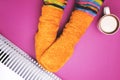 Girl hot near the heater in socks Royalty Free Stock Photo