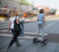 Girl on the hoverboard on the street of the city in motion blur