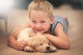 Girl hug her puppy in portrait, relax at home and happy with sleeping golden retriever and child with smile. Happiness Royalty Free Stock Photo