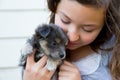 Girl hug a little puppy dog gray hairy chihuahua