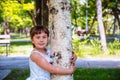 Girl hugging a birch tree in the park Royalty Free Stock Photo