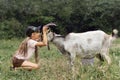 A girl hugging her goat as a friend in the village Royalty Free Stock Photo