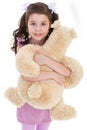 Girl hugging her teddy bear. Royalty Free Stock Photo