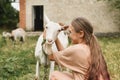 A girl hugging her white goat as a friend in the village Royalty Free Stock Photo