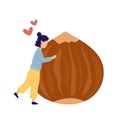 Girl hugging huge hazelnut with hearts above