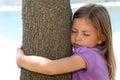 Girl hugging tree