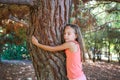 Girl hugging tree in park Royalty Free Stock Photo