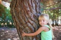 Girl hugging tree in park Royalty Free Stock Photo