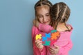 Girl hugs autistic sister tightly as sign of support and comforts. Royalty Free Stock Photo