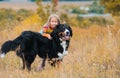 girl hugs a dog, on walk with her four-legged friend