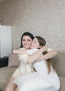 a girl hugs an excited young mother, shows love and affection, sharing a close tender moment together