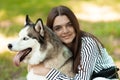 The girl hugs her furry friend. The teenager poses for a photo. The dog and it`s owner